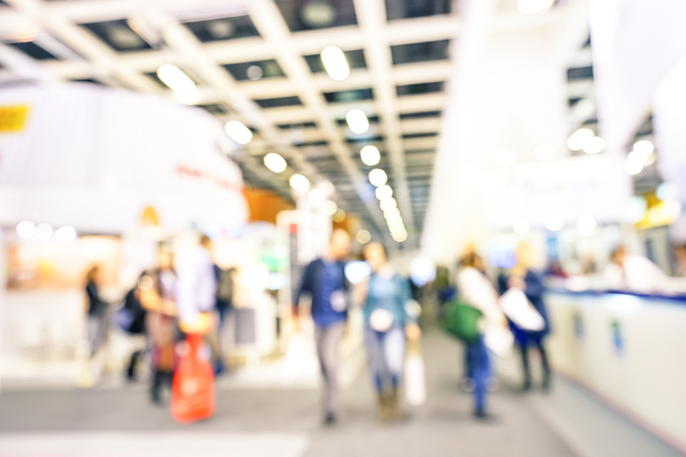 Defocused bokeh abstract of generic trade show expo stand - Concept of business social gathering for international tradeshow of tourism meeting exchange - Soft overexposed desaturated filter