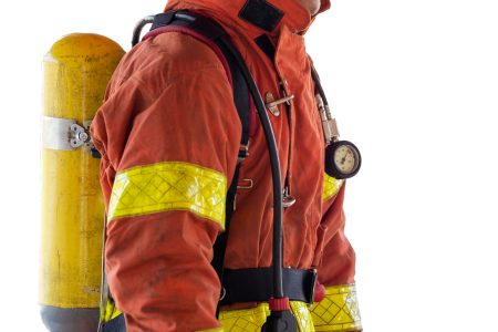 close up single fireman in fire fighting protection suit and equipment isolated on white background with cliping path
